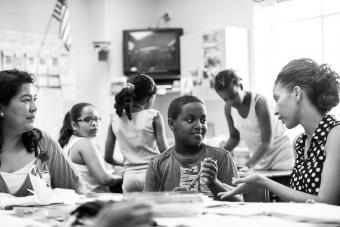 Teacher talking with young student