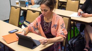 woman on tablet at CEC convention