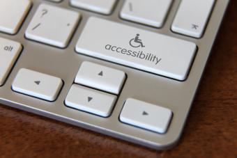 Picture of a computer keyboard with a button that has the accessibility sign and says "accessibility"